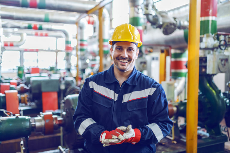 Smiling worker in well lit, productive work environment